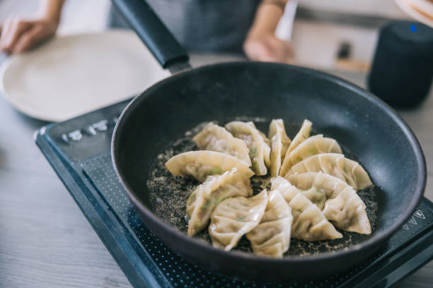istock Frying gyozas at home 1325387561