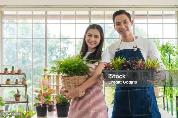 Young Entrepreneur Plant Sellers Opened The Online Floral Plant Shop In The House Florist Or Gardeners Working In A Garden Nursery Stock Photo - Download Image Now