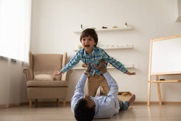 istock Indian father play with excited small son 1325390964
