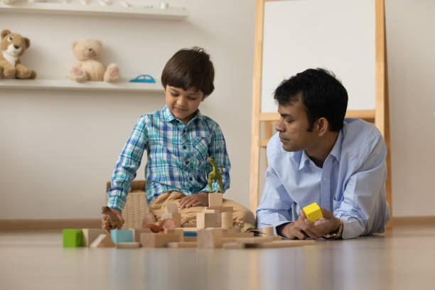istock Indian father play toys with small son 1325390973