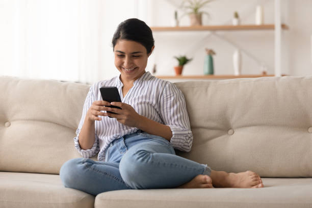 istock Smiling Indian woman use cellphone browsing internet 1325391008