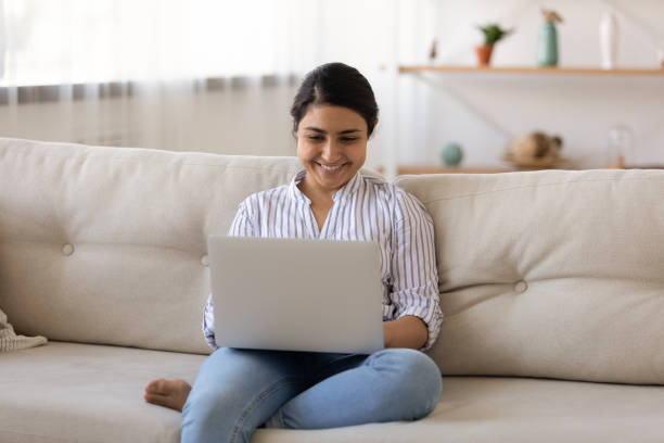 istock Smiling woman use laptop talking on video call 1325391020