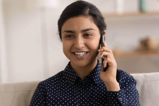 istock Young Indian woman talk on cellphone gadget 1325391048