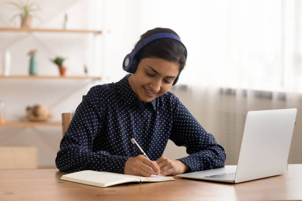 istock Smiling Indian teenager study online on computer 1325391057