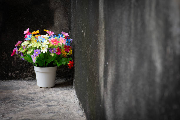 istock Multicolored bouquet in a vase placed on an antique background. 1325391413
