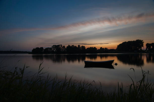 istock a lonely boat on a lake in Masuria 1325392581