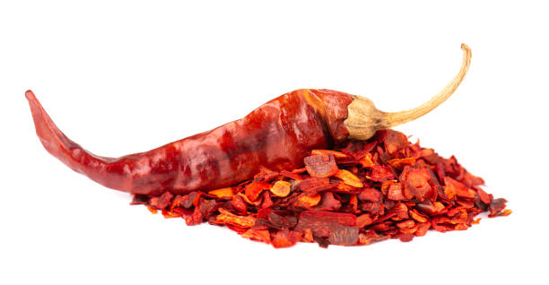 istock Dried red chili flakes with seeds, isolated on white background. Chopped chilli cayenne pepper. Spices and herbs. 1325395953
