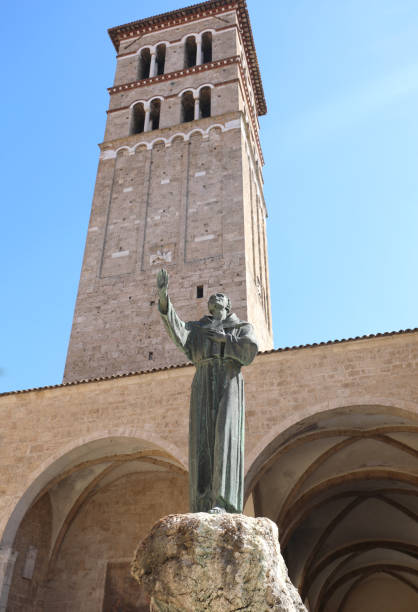 bell tower of the cathedral and the statue of Saint Francis of Assisi in the city of Rieti in the Lazio region in central Italy without people high bell tower of the cathedral and the statue of Saint Francis of Assisi in the city of Rieti in the Lazio region in central Italy without people rieti stock pictures, royalty-free photos & images