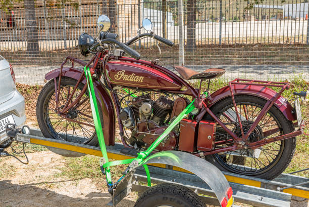 Hamburg, Germany 16. October 2022: Golden jet helmet shines in the sun, attached to the handlebars of an american motorcycle, parked somewhere in hamburg - germany