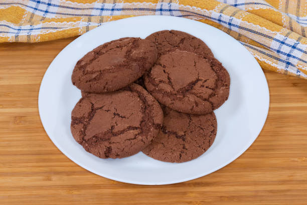 istock Round chocolate cookies on dish on a wooden surface 1325403877