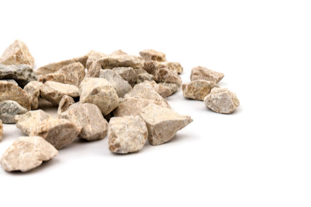 istock Gray small rocks ground texture isolated on white background. Small road stone. 1325403934