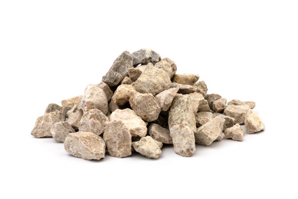 istock Gray small rocks ground texture isolated on white background. Small road stone. 1325403951