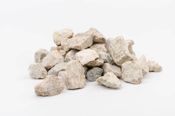 istock Gray small rocks ground texture isolated on white background. Small road stone. 1325403989