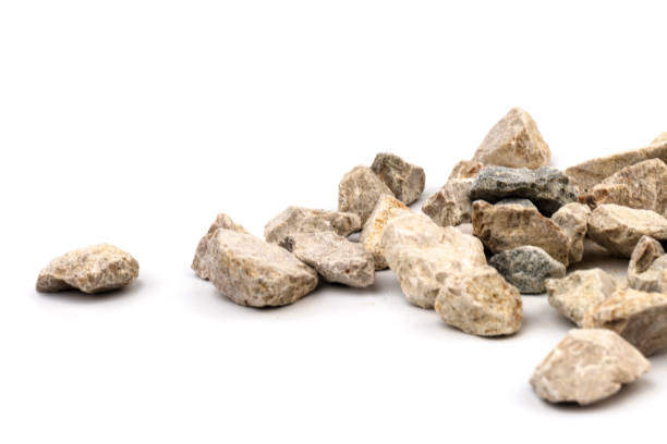 istock Gray small rocks ground texture isolated on white background. Small road stone. 1325403990