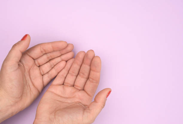 istock two female hands folded palm to palm on a purple background 1325405310