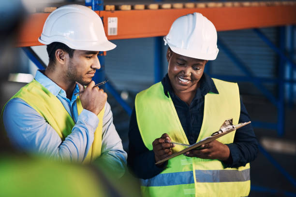 istock Shot of two young contractors standing in the warehouse and having a discussion while doing a stock-take 1325406292