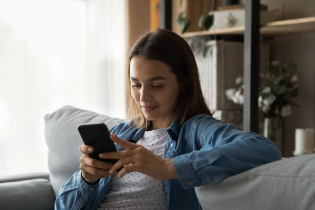 istock Relaxed young pretty woman using smartphone applications. 1325412496