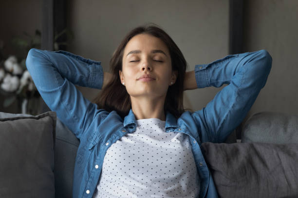 istock Happy relaxed attractive young woman sleeping on cozy sofa. 1325412497