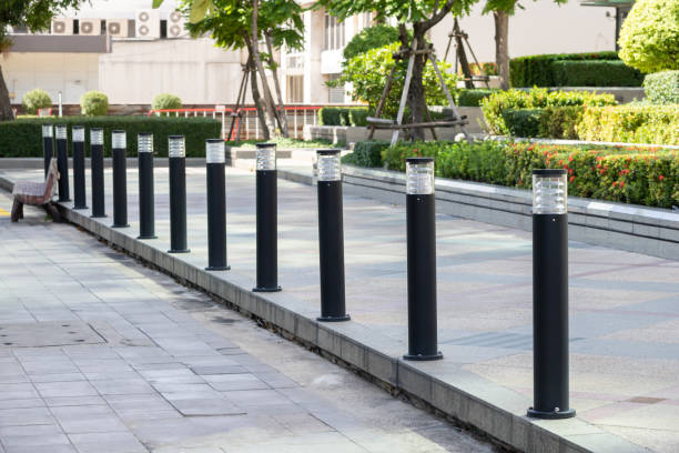 black light steel bollards on a footpath.