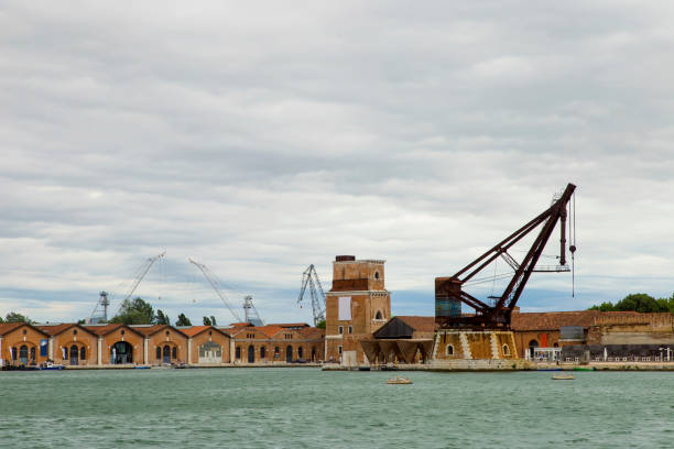 Industrial shipyards (Arsenale di Venezia) in Italy, Venice. Loading cranes and docks.