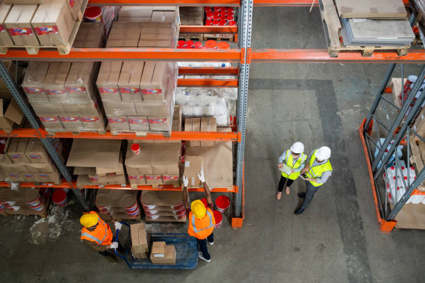 istock Two groups of employees working in warehouse 1325417124