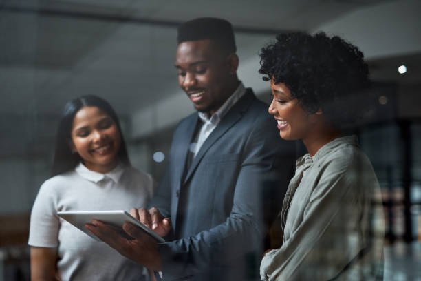 istock Shot of three businesspeople working in a modern office 1325417178