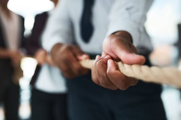 istock Cropped shot of unrecognizable businesspeople pulling on a rope 1325418332