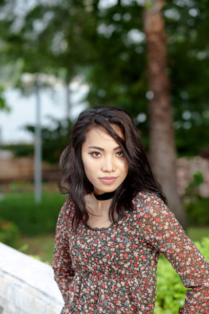 istock Confident looking filipina transgender in park 1325419630