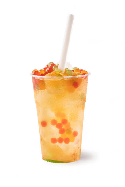 Bubble Tea, Isolated on White Background Bubble Tea, Isolated on White Background – Colorful, Fresh Orange Boba Drink with Fruit Fizzy Jellies and Ice Cubes, Wet with Droplets – Close Up Macro on Transparent Plastic Cup, with Straw bubble tea photos stock pictures, royalty-free photos & images