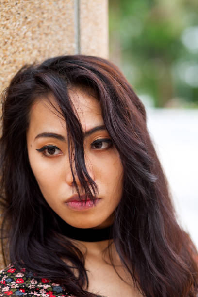 istock Sadly looking filipina transgender with hair falling into face 1325419798