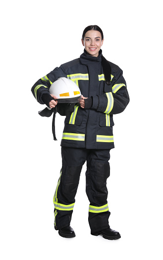 Full length portrait of firefighter in uniform with helmet on white background