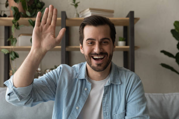 istock Joyful friendly young 30s man starting online video call meeting. 1325420944