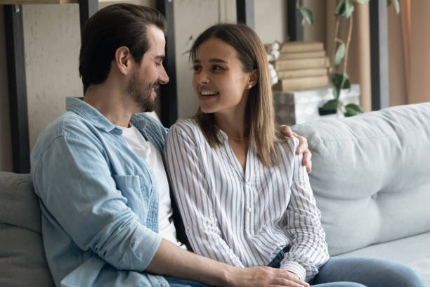 istock Happy loving married couple discussing future plans at home. 1325420953