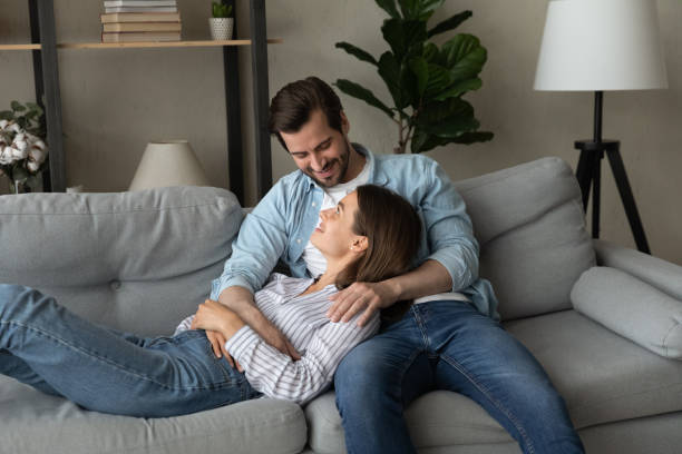 istock Happy bonding young family couple resting on comfortable sofa. 1325420982