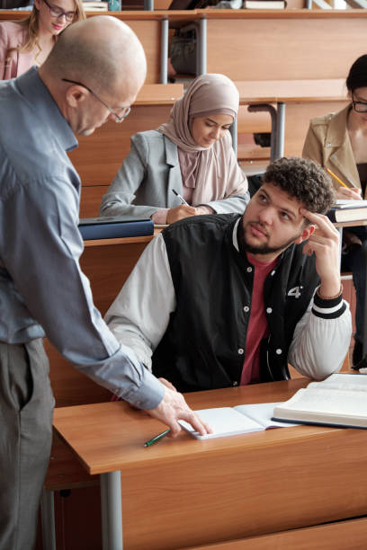 istock Student looking at his teacher during consultation 1325422755