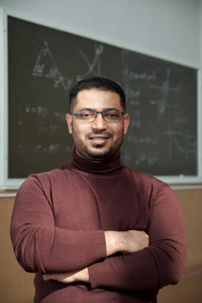 istock Happy teacher crossing arms by chest 1325422844