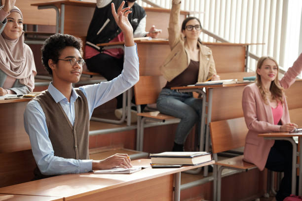 istock Group of intercultural students raising hands 1325422847