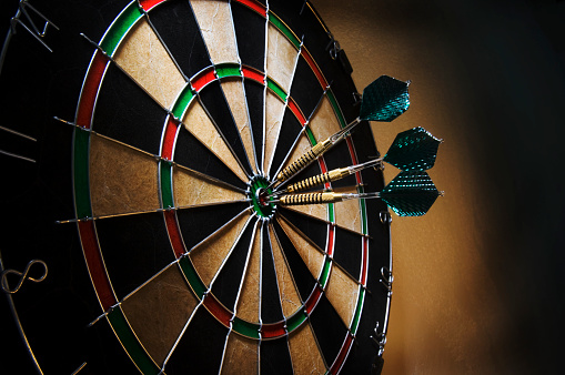 red darts in the dartboard center. business target or goal success and winner strategy concept. banner with copy space
