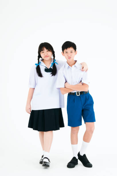 学校に戻る。タイの高校の制服を着た少年少女。白い背景の子供たち。 - high school student asian ethnicity teenager education ストックフォトと画像