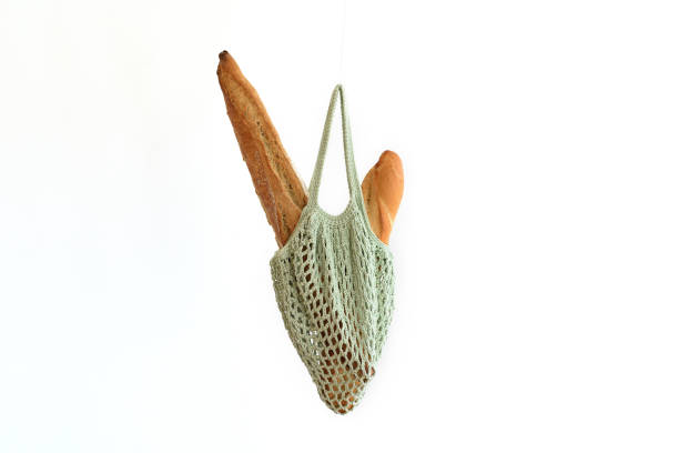 istock Mint green crochet bag with breadsticks, reusable concept 1325424014