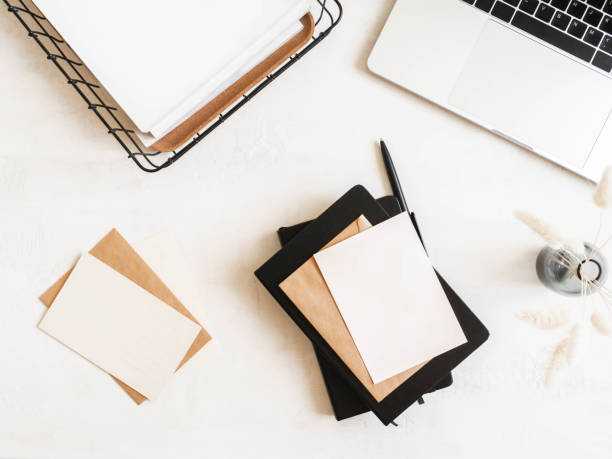istock Home office desk with laptop, notebook, basket, flowers, envelopes and postcards 1325426276