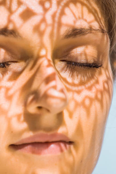 istock Headshot of a female face behind summer shadow 1325428353