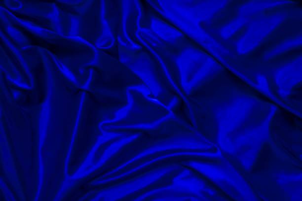 istock Elegant iridescent blue fabric in waves. 1325429281