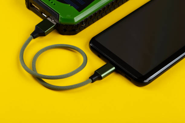istock Smartphone Charging with Power Bank on Yelloy Background. 1325430628