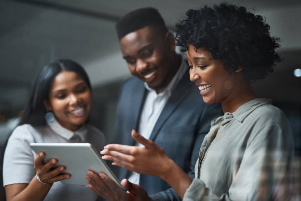 istock Shot of three businesspeople working in a modern office 1325431373
