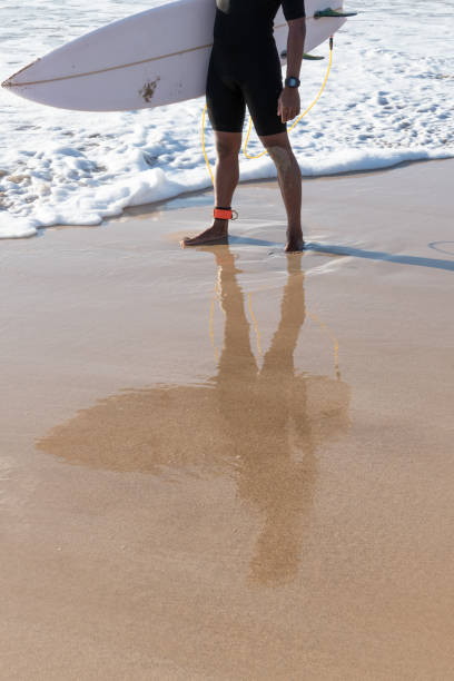 istock Reflection of a surfer on the beach shore 1325432050