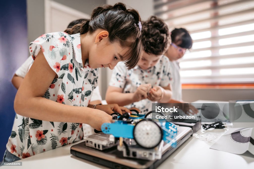 Students In Computer Coding Class Building And Programing Robot Vehicle ...