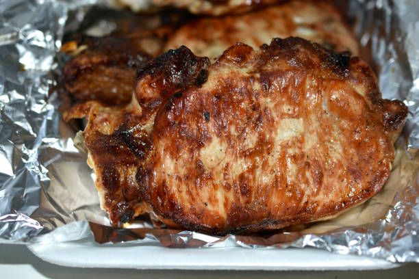 fried pieces of delicious pork meat on foil - salt beef fried angle imagens e fotografias de stock