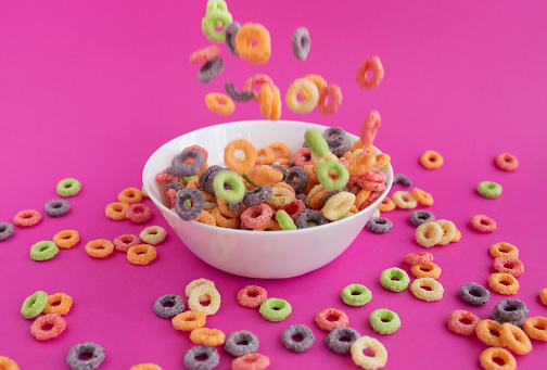 plate of dry cereal breakfast cereals on pink background
