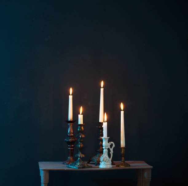 istock candlesticks with burning candles on  dark blue background 1325439736